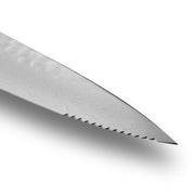 Shun | Premier Serrated Utility Walnut, 6.5: Close-up of a knife blade with scalloped serrations and Damascus-style pattern, ideal for versatile cutting tasks.