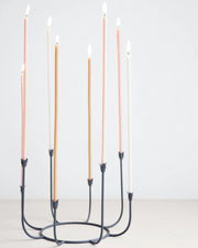The Floral Society | Beacon Long Stem Candelabra featuring lit candles in elegant metal holders, perfect for enhancing kitchen or dining decor.