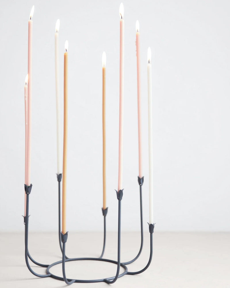 The Floral Society | Beacon Long Stem Candelabra featuring lit candles in elegant metal holders, perfect for enhancing kitchen or dining decor.
