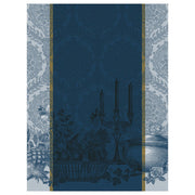 Le Jacquard Français Festin Tea Towel featuring a navy and sky-blue still life with a candelabra, fruit basket, tureen, and damask border.