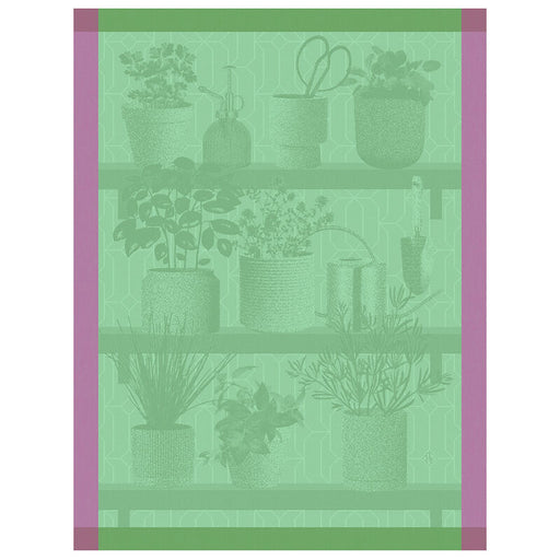 Le Jacquard Français | Herbes Fraiches Tea Towel, Green displayed with potted herbs and gardening tools on wooden shelves, emphasizing culinary and kitchen application.