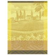 Gold-toned illustration of a vineyard estate on Le Jacquard Français Vignoble Tea Towel, showcasing grapevines and a château, embodying Burgundy's wine heritage.