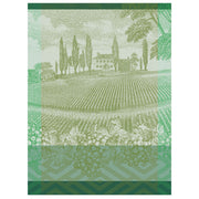 Le Jacquard Francais VIGNOBLE GREEN TEA TOWEL features a vineyard scene with chateau, cypress trees, and grapevine motifs, celebrating Burgundy's wine heritage.