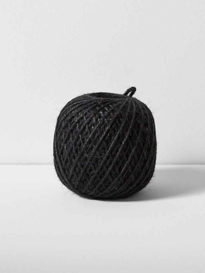 Earth & Nest | Black Jute Twine Ball, 3-ply, spooled in Scotland, resting on a white surface. Perfect for kitchen use or decorative storage.