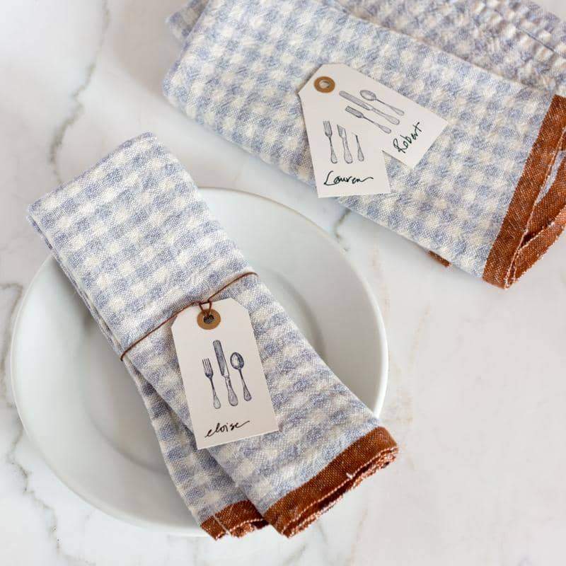 Caravan Home's 20 x 30 Gingham Blue & Cognac Towels with utensil tags, perfect for rustic table settings at Athens Cooks.