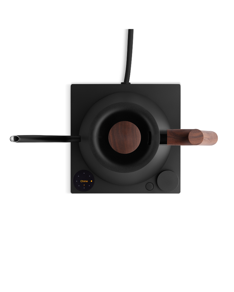 Fellow | Stagg EKG Pro Electric Kettle with walnut accents on a black induction base, featuring digital display and control dial for precise brewing.
