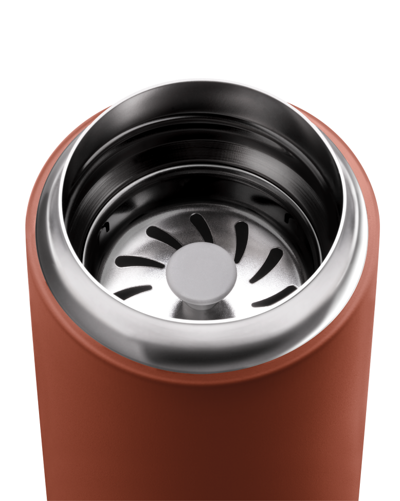 FELLOW | Carter Move Mug, Sienna / 16 oz, featuring a stainless-steel interior, orange exterior, and built-in strainer for tea or ice retention, ideal for travel.