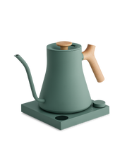 FELLOW | Stagg EKG Pro Electric Kettle in matte green with maple accents, ideal for precision pour-over coffee, featuring variable temperature control on a sleek base.