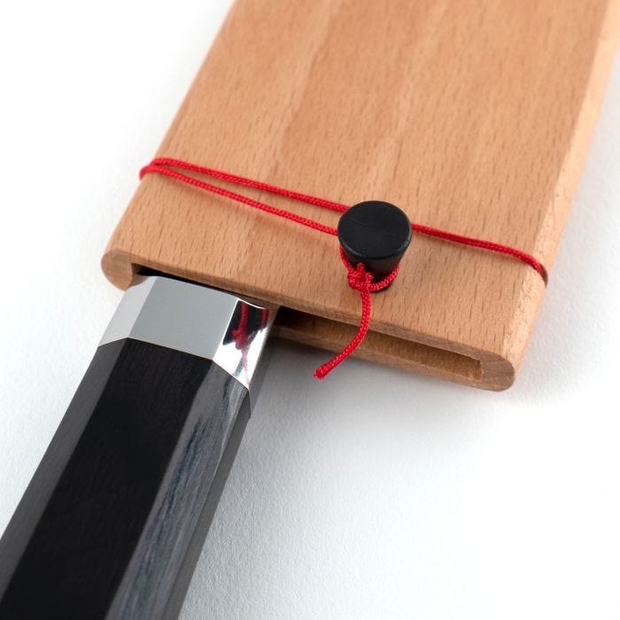 Shun Dual Core Santoku, 7 inches, features an octagonal handle in a wooden sheath, showcasing Japanese craftsmanship and versatility for kitchen tasks.