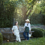 The Floral Society | Watering Can - White, features a modern design with a curved handle and extended spout, crafted from copper-plated stainless steel for durability.