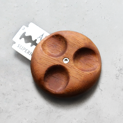 Wire Monkey | UFO NUX Lame: A polished wood organizer with recesses and a visible razor blade, designed for easy handling, inspired by moon jellyfish.