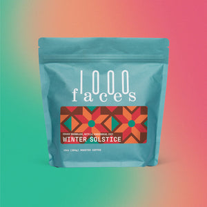 1000 Faces Coffee - Winter Solstice, whole bean coffee in a blue bag with white text, highlighting sustainable practices and exceptional flavor, available at Athens Cooks.