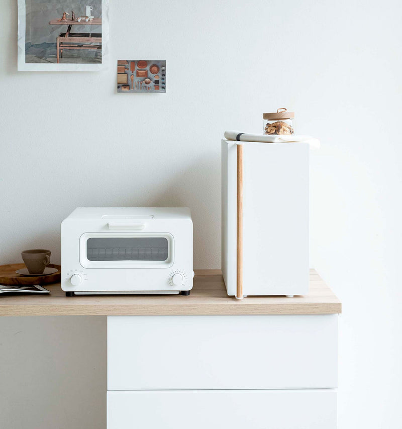 Yamazaki Home Bread Box, Vertical, Steel + Wood sits elegantly on a minimalist kitchen counter, blending seamlessly with Scandinavian-inspired decor and compact appliances.