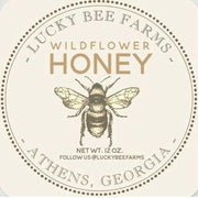 Lucky Bee Farms Honeycomb Jar from Athens, GA, featuring a bee-themed label and coaster, highlighting raw, local wildflower honey's natural sweetness.