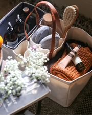 CapaBunga Grocery Tote with red handles, featuring separate compartments for secure transport of groceries, showcased in close-up alongside white flowers and books.