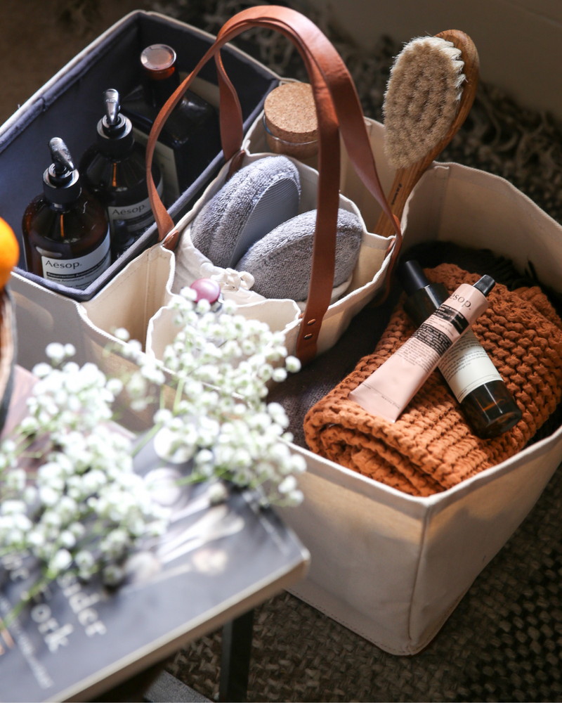 CapaBunga Grocery Tote with red handles, featuring separate compartments for secure transport of groceries, showcased in close-up alongside white flowers and books.