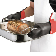 Kitchen Grips | Chef's Mitt - Large - Black, shown handling a roasting pan with cooked meat, highlighting its heat protection and non-slip grip features.