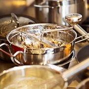 Rösle Passetout Food Mill with stainless steel construction, includes supplementary handle and two sieve disks, .08 and .12, designed for stable milling and processing.