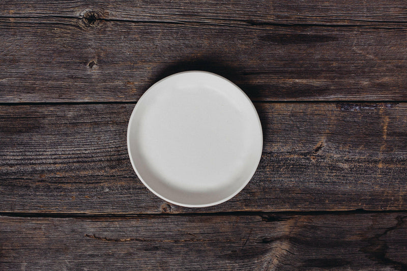 Looks Like White | Scandi Cereal Bowl by Trudy Crane, a hand-painted ceramic piece showcasing elegant simplicity, centered on a rustic wooden tabletop.