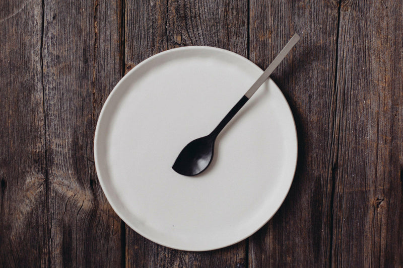 Looks Like White | Scandi Cereal Bowl on wooden table with modern spoon, showcasing minimalist elegance and organic design, perfect for enhancing dining experiences.