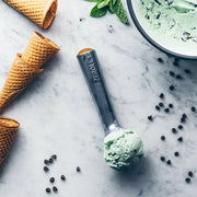 Zeroll | Ice Cream Scoops - 3 oz Scoop - Aluminum shown carving a scoop, featuring heat-conductive handle for smooth, efficient portioning, ideal for home or parlor use.