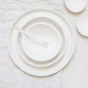 Top-down view of Looks Like White | Scandi Cereal Bowl, nested with plates, showcasing elegant simplicity and organic form, part of Trudy Crane's curated ceramics collection.