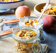 Le Parfait Super Jars - 1L filled with peach parfait and granola, showcasing airtight seal and versatile use for preserving and displaying kitchen creations.
