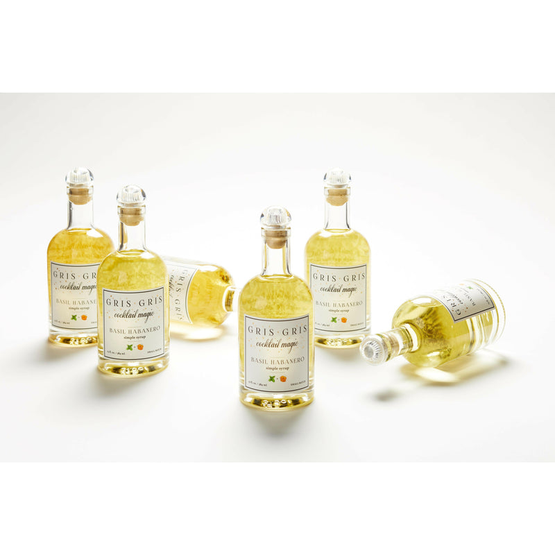 Gris Gris | Cocktail Magic Simple Syrup - Yuzu Serrano bottles, showcasing small-batch mixers with aromatic herbs and peppers, ideal for elevating cocktails or mocktails.