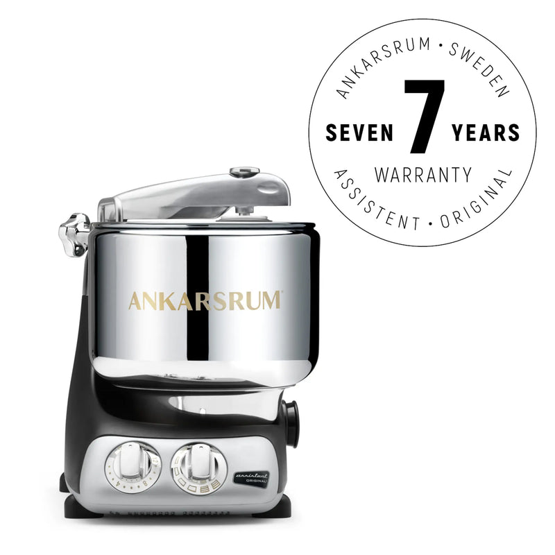 Ankarsrum stand mixer in polished chrome with a Seven Years Warranty badge, featuring a 7-liter bowl and 1500 W motor for versatile kitchen use.