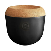 Emile Henry Garlic Pot - Clay: Black and tan ceramic pot with cork lid, designed for storing and ventilating garlic to maintain freshness.