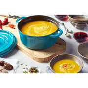 Staub Round Cocotte, 9 qt, ideal for slow-cooking and braising, features a lilac enamel finish and innovative self-basting lid for tender, flavorful dishes.