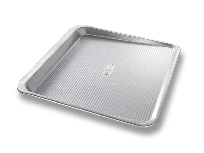 USA Pan | Cookie Tray Pans - Medium features an innovative scoop design with a secure handle for easy cookie release and smooth transfer to cooling racks.