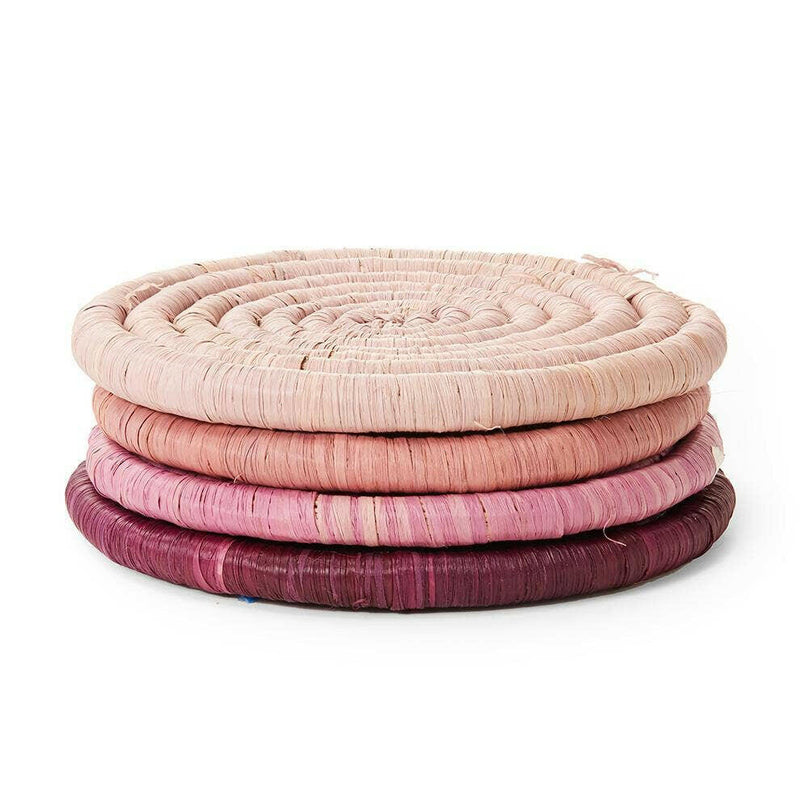St. Frank | Ombré Coaster Collection - Blue: A stack of handmade woven coasters, tied with black ribbon, crafted from sun-dried raffia and banana leaf stems.