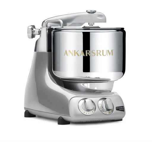 Ankarsrum Assistent Original stand mixer with a silvery finish, featuring a stainless-steel mixing bowl and dual control knobs, ideal for heavy dough mixing.