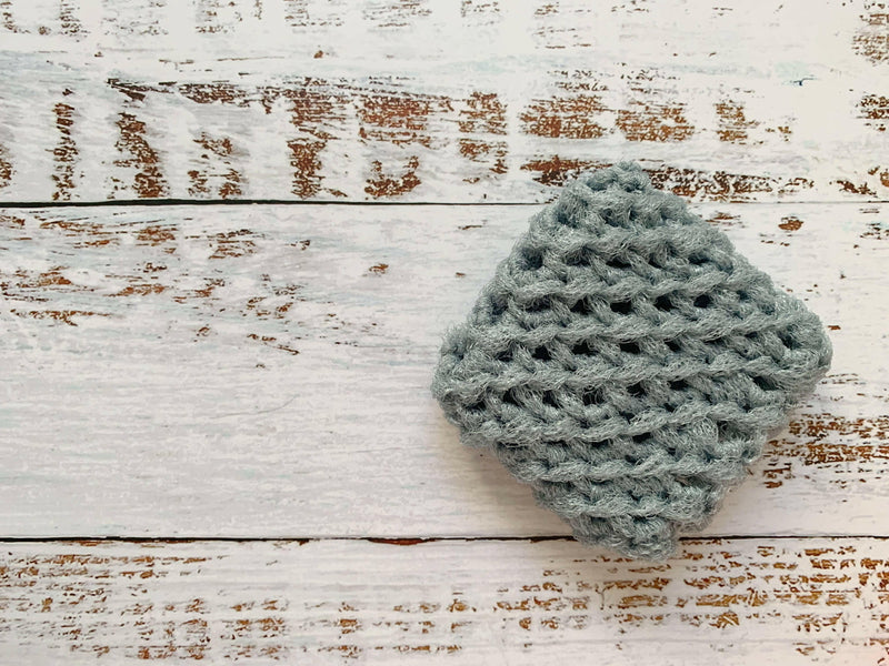 Close-up of Dot and Army's navy dish scrubbies, handmade from durable nylon, designed for effective cleaning and quick drying, enhancing any kitchen routine.