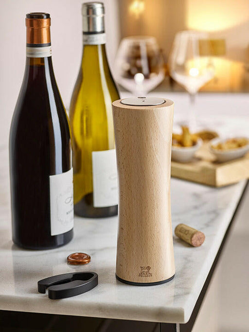Peugeot Elis Reverse Rechargeable Electric Corkscrew - Black, showcased on a marble counter with wine bottles, glasses, and snacks, highlighting its elegance and functionality for wine enthusiasts.