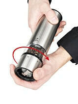 Peugeot | Elis Sense Electric Salt + Pepper Mills - Salt: A stainless-steel manual spice grinder in use, showcasing its sleek design and efficient grinding mechanism.