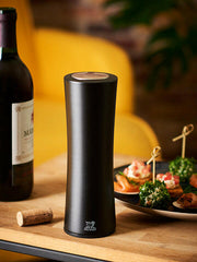 Peugeot Elis Reverse Rechargeable Electric Corkscrew beside a red wine bottle and seafood canapés, showcasing effortless uncorking with elegant beechwood design.