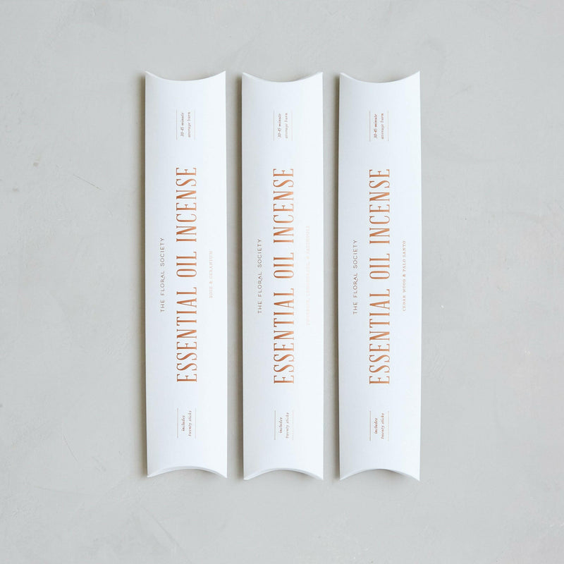 The Floral Society's handcrafted essential oil incense, featuring earthy and citrusy Cedar Wood & Palo Santo, displayed in packaging with 20 sticks for calming ambiance.