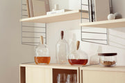 LSA International Float Decanters with walnut stoppers, expertly designed for serving spirits, enhancing any home bar with their contemporary, mouth-blown glass elegance.
