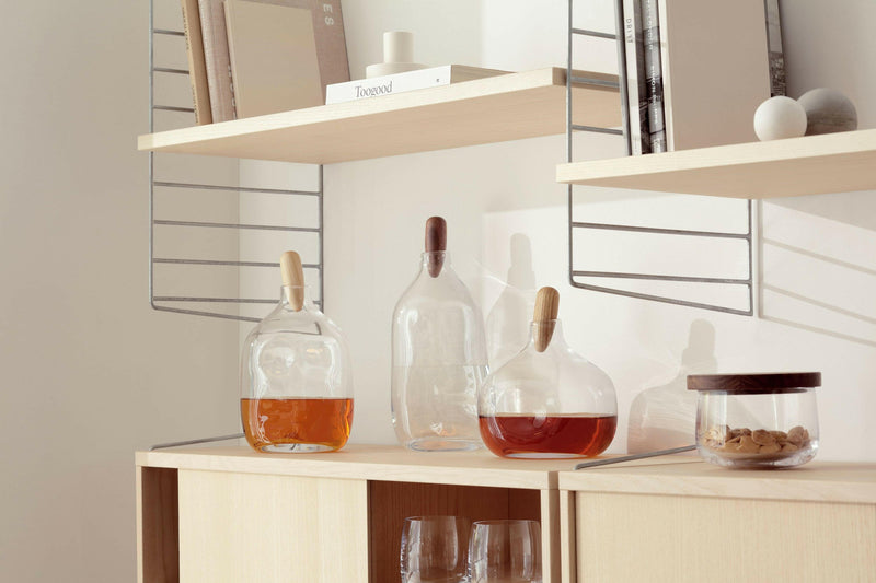 LSA International Float Decanters with walnut stoppers, expertly designed for serving spirits, enhancing any home bar with their contemporary, mouth-blown glass elegance.