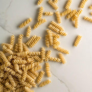Close-up of Bona Furtuna's organic Fusilli pasta, showcasing its spiral shape and craftsmanship, made from heirloom wheat using traditional Sicilian milling techniques.