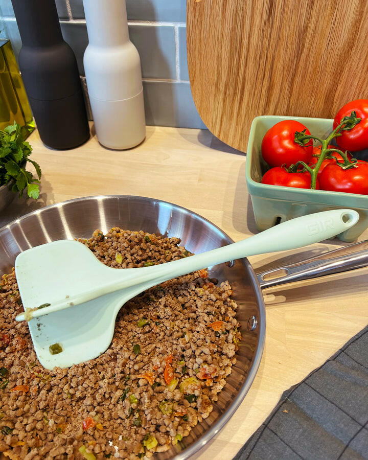 GIR Quad Chopper in action, breaking up food in a pan, highlighting its utility for efficient meal preparation.