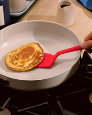 GIR | Ultimate Flip - Teal effortlessly slides under pancakes, shown on a red spatula, ideal for delicate flipping without damage.