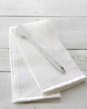 GIR | Skinny Spatula - Navy, showcased on a white towel, highlighting its sleek, antimicrobial unibody design ideal for hygienic, durable kitchen use.