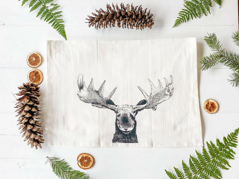 Your Green Kitchen | Holiday Tea Towels feature pinecone and moose embroidery, crafted from organic cotton, perfect for stylish and functional kitchen use.