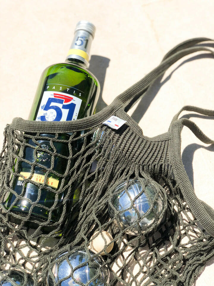 Filt | French Market Bags - Gold, showcasing a stylish string bag holding a green glass bottle, embodying eco-conscious shopping elegance and practicality.