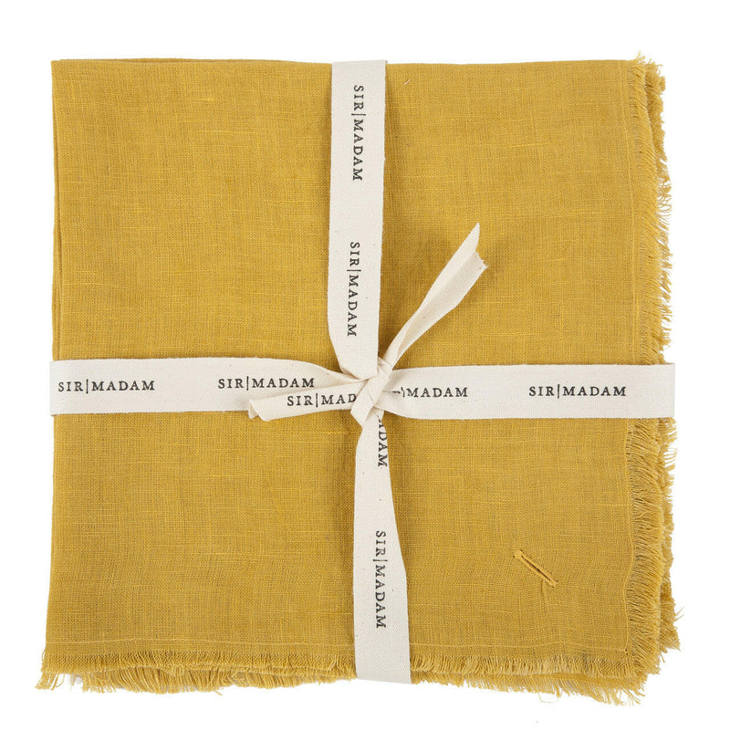 Sir|Madam Linen Frayed Edge Napkins - Curry - Set of 4, tied with a white ribbon, showcasing their neat presentation and quality.