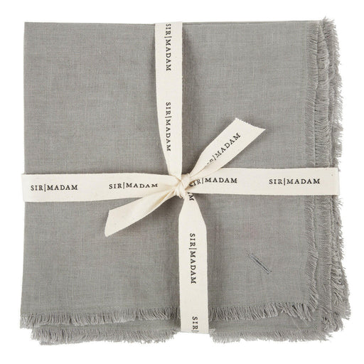 Sir|Madam Linen Frayed Edge Napkins - Curry - Set of 4, neatly tied with a white ribbon, showcasing their simple, elegant design.