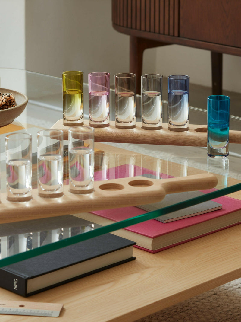 LSA International Shot Glass Set & Paddle features six tall shot glasses on a sleek oak paddle with handles, ideal for stylish spirit serving.
